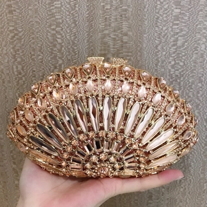Detailed view of the shell-shaped clutch with champagne gold rhinestones and metal frame
