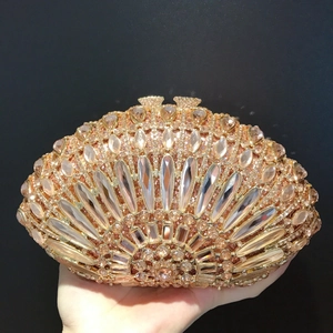 Macro view of crystal-encrusted evening clutch with amber and champagne rhinestones