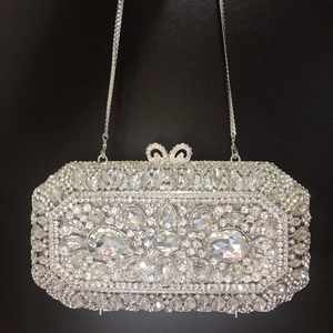 Detailed close-up of silver rhinestone evening bag with intricate floral crystal patterns