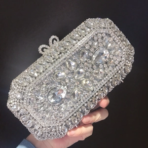 Macro detail of geometric crystal rhinestone patterns on a luxury champagne evening clutch