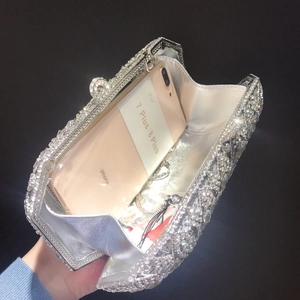 Detail view of the champagne gold rhinestone evening clutch showing iPhone capacity fit