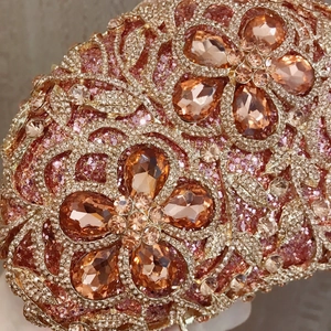 Close-up of sparkling crystals and floral rhinestone patterns on luxury evening clutch