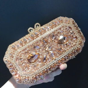Detail of luxurious champagne gold rhinestone clutch with exquisite hollow metal clasp