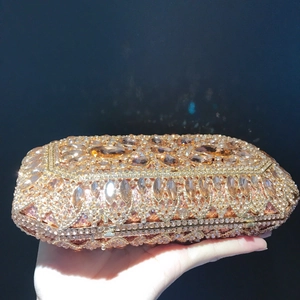 Macro view of luxurious champagne gold evening clutch with embedded rhinestones and gems