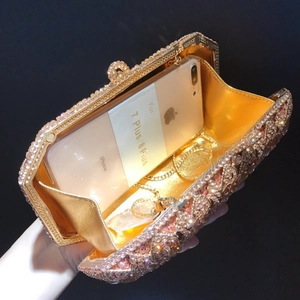 Detail view of rhinestone clutch bag interior showing spacious capacity for smartphones