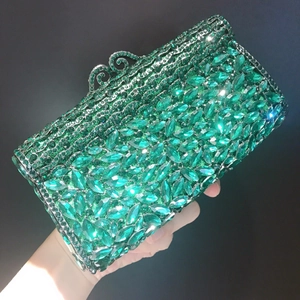 Luxury emerald green rhinestone evening clutch bag with ornate metal buckle for gala events