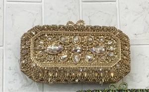 Close-up of sparkling gold crystals and bow clasp on the luxury evening clutch bag