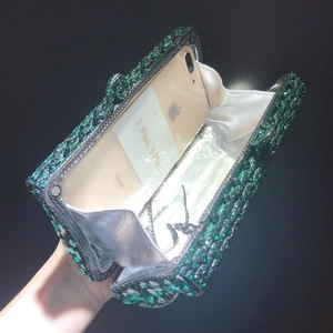 Green rhinestone evening clutch bag showing interior capacity for a 5.5 inch smartphone