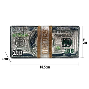 Detailed view of the luxury money clutch featuring sparkling crystals and 100 dollar pattern