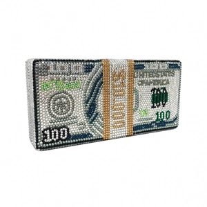 Close-up of luxury dollar stack evening clutch with sparkling rhinestones and gold strap