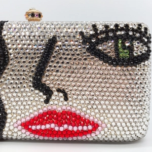 Artistic evening clutch bag with crystal-encrusted face design and gem clasp closure