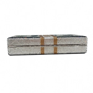 Macro shot of a dollar stack evening clutch with luxury rhinestones and gold hardware