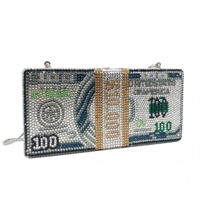 Macro detail of hundred dollar bill design with crystals and silver chain on clutch bag