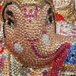Vue macro d'une pochette éléphant en cristal faite main avec des détails en strass colorés