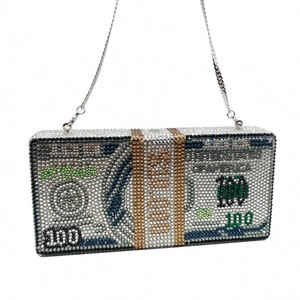 Detailed view of handmade dollar-shaped clutch bag with sparkling crystals and silver chain