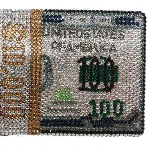 Detailed close-up of handmade sparkling crystal rhinestones on a dollar money clutch bag