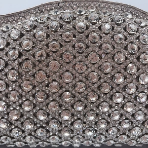 Luxury rhinestone evening clutch featuring a silver hollow metal box and crystal chain