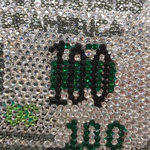 Macro detail of dollar clutch showing silver and green rhinestones and 100 digit pattern