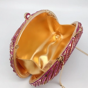 Pink rhinestone evening clutch bag with wave pattern and gold metal chain strap