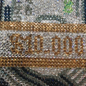 Macro shot of high-density rhinestone inlay detailing with branded luxury logo design