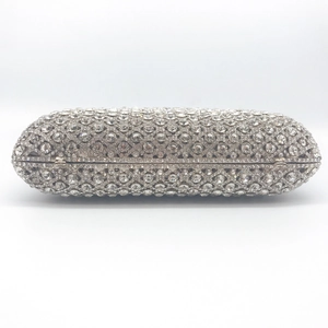 Sparkling silver capsule evening clutch bag with dense rhinestone pavé and chain strap