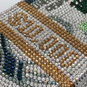 Macro shot of colorful rhinestones and premium metal craftsmanship on the dollar clutch