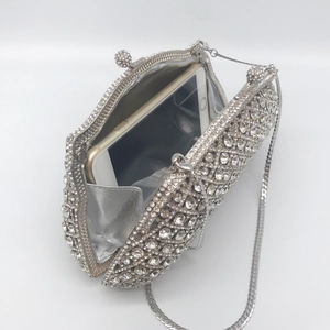 Silver rhinestone evening clutch with hollow metal frame and chain strap showing phone capacity