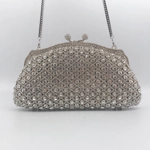 Silver hollow metal evening clutch with shimmering rhinestones and chain strap