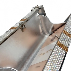Detail view of rhinestone clutch interior showing capacity for a large smartphone