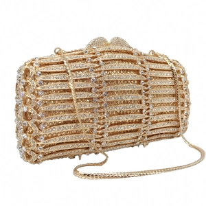 Macro shot of gold evening clutch with sparkling rhinestones and heart-shaped clasp detail
