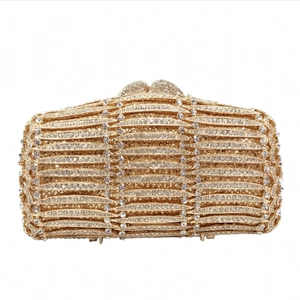Luxurious gold evening clutch bag with sparkling rhinestone wave patterns and metal clasp
