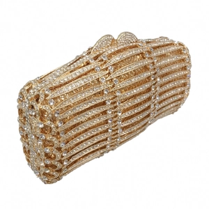 Macro view of gold evening clutch featuring radial rhinestone patterns and wave metal clasp