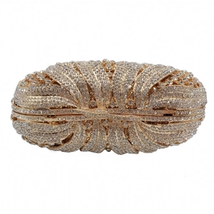 Detailed view of waves of sparkling crystals set in a golden metal evening clutch bag