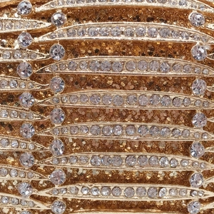 Macro detail of luxury evening clutch with gold glitter and rows of sparkling rhinestones