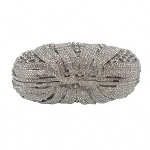 Close-up of silver rhinestone evening clutch showing metal frame and clasp detail