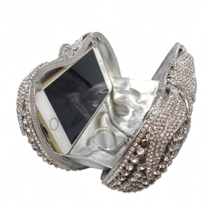 Silver tomato shaped evening bag with sparkling rhinestones showing internal phone capacity