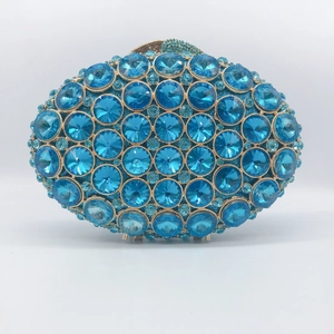 Luxury oval evening bag with light blue crystals and gold-tone metal frame