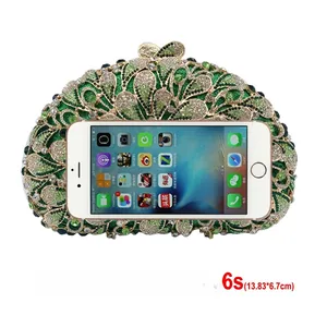 Green rhinestone evening clutch with gold metal frame compared with a mobile phone