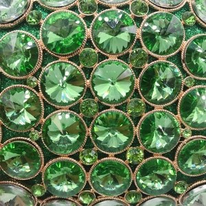 Green crystal evening clutch bag with emerald rhinestones and gold metal frame detailing