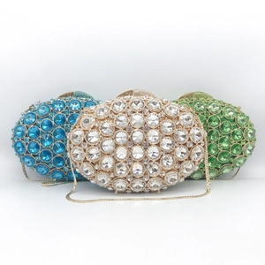 Elegant hollow metal evening clutch with crystals in blue, silver, and emerald green