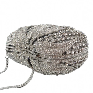 Detailed macro view of silver rhinestone evening clutch with layered crystal petal pattern