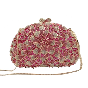 Macro detail of pink floral rhinestone pattern and golden petal clasp on evening bag