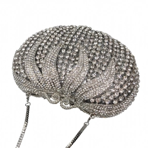 Detailed close-up of a silver rhinestone evening clutch bag with detachable metal chain