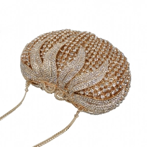 Detail of champagne gold evening bag featuring hollow metalwork and sparkling rhinestones