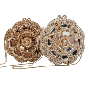 Detail of flower-shaped evening clutches with intricate rhinestones and gold/silver finish