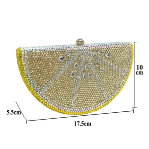 Macro shot of lemon clutch bag showing yellow rhinestones and detailed fruit texture