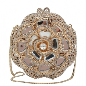 Detailed view of luxury gold floral evening clutch with crystals and bow clasp