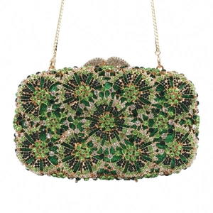 Detail of evening clutch with green and black rhinestones in radial floral pattern