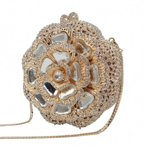 Detail of floral evening clutch featuring gold alloy setting with intricate crystal inlay