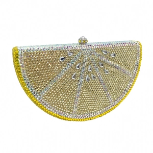 Detailed view of lemon-shaped evening clutch bag with sparkling yellow and silver crystals